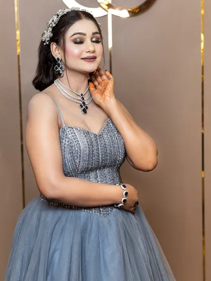 This engagement look feels like a dream. The soft grey-blue gown is paired with a cool-toned makeup look, featuring shimmering eyelids, rosy cheeks, and a beautiful crystal headband.