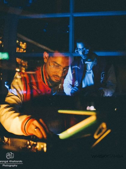 A creative reflection shot of me at the DJ console at Whisky Samba. The moody lighting and city view capture the sophisticated vibe of my sets at premium lounges.