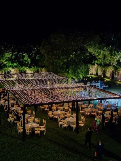 An identical shot to ID 8, showing the magnificent scale of the outdoor reception decor with its canopy of lights against the night sky.
