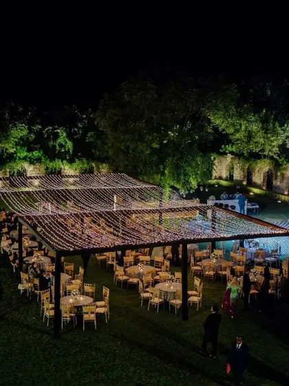 An identical shot to ID 8, showing the magnificent scale of the outdoor reception decor with its canopy of lights against the night sky.