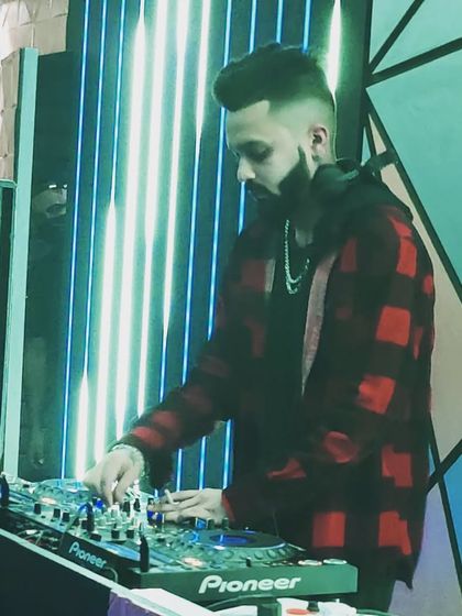 Don't wait for opportunity, create it. A focused shot of me mixing at Badmaash Lounge, under the watchful eye of the tiger mural.