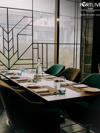 A beautifully set table in Zodiac, ready for guests. The modern chairs and minimalist place settings reflect our commitment to sophisticated dining.