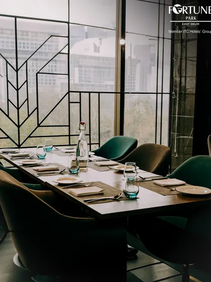 A beautifully set table in Zodiac, ready for guests. The modern chairs and minimalist place settings reflect our commitment to sophisticated dining.