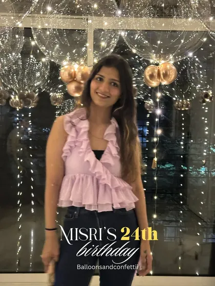 The birthday girl enjoying her special day, with the glowing bubble balloons creating a beautiful, sparkling backdrop for her photos.