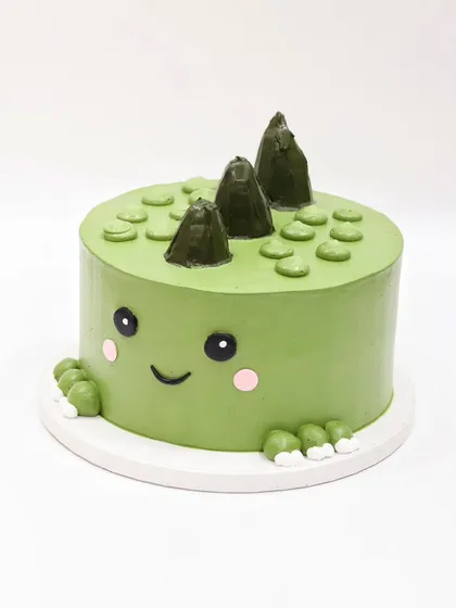 Another angle of the simple and adorable green dinosaur cake.