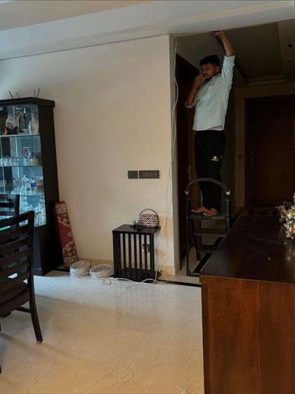 This image shows an installation in progress inside a home in GK-1. We are running cables neatly along the wall to connect an indoor camera.