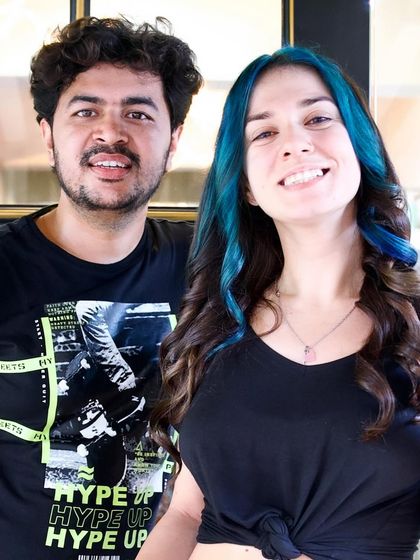 A happy client with her new blue money piece highlights. This is a trendy way to frame the face and add a bold pop of color without a full-head commitment.