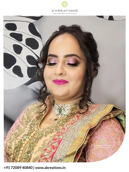 A festive makeup look with shimmering pink eyeshadow and a bold lip, paired with a classic updo for a traditional celebration.