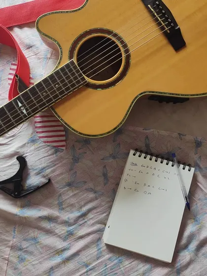 Every song starts here, with a simple notebook and a guitar. This is where I jot down the chords, lyrics, and feelings you share with me, laying the foundation for a truly personalized anniversary or birthday song.