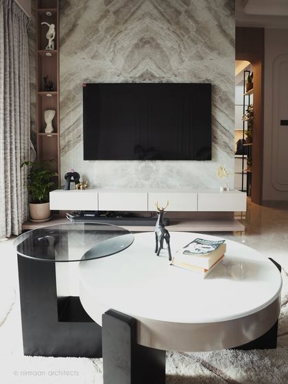 The TV wall in our Sai World Empire project is a statement of understated elegance. The book-matched marble creates a stunning symmetrical pattern, flanked by built-in shelves for curated decor.