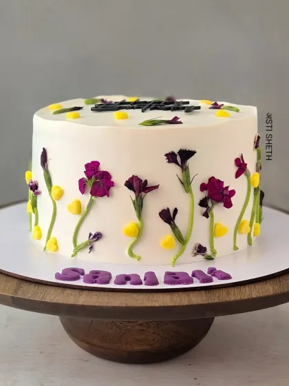 A beautiful cake with pressed edible flowers, creating a delicate and natural "meadow" look. This is my signature Mocha Orange flavour.