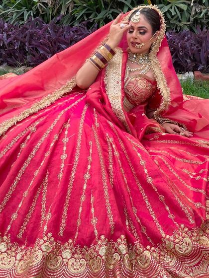 A beautiful outdoor shoot with our rani pink lehenga. The natural light brings out the richness of the color, making it ideal for a day wedding portfolio.