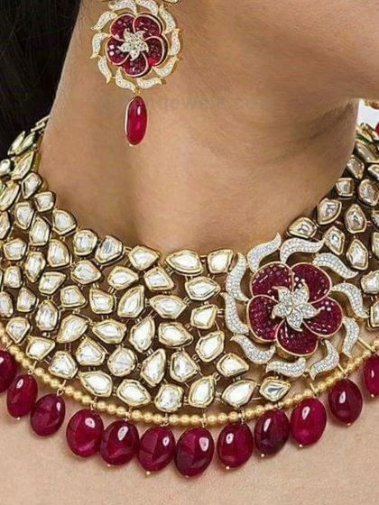 Another view of the exquisite uncut Polki necklace with the floral ruby motif, highlighting its vibrant color and sparkle.