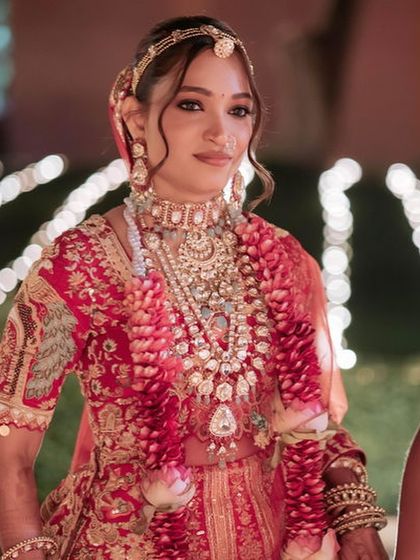 A portrait of the bride looking regal and elegant. The makeup is timeless, with a focus on flawless skin and defined features.