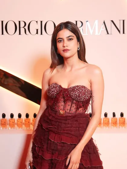 Aaditi Pohankar at the Giorgio Armani event. Her makeup is chic and event-ready, with a defined eye and glowing skin that perfectly matches her glamorous strapless red dress.