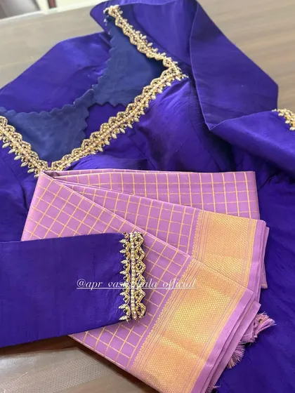 A contemporary blouse design in royal blue with a unique scalloped neckline and simple sleeve embroidery, paired with a checked lavender fabric.