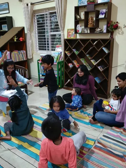 The storyteller encourages the children to stand up and act out a part of the story, combining reading with active play.