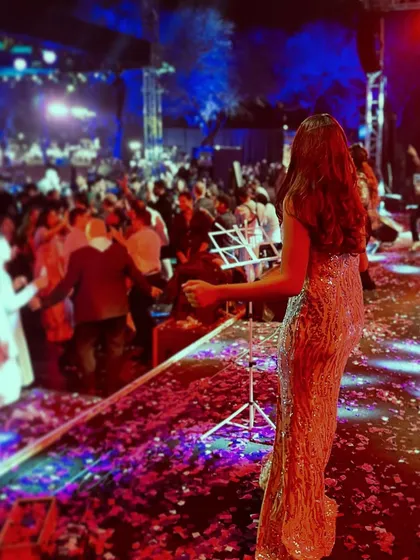 Our lead vocalist, Shanelle, looking out at a dance floor filled with energy and confetti. Our goal is always to connect with the audience and make them a part of the show.