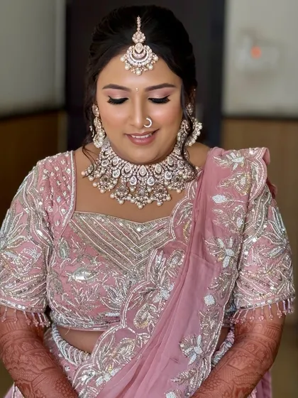A close-up with eyes closed, showing the soft pink eyeshadow and perfectly blended base. This look is ideal for the bride who loves a touch of color.