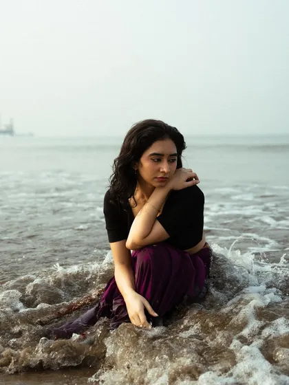 A quiet, contemplative moment sitting in the surf. This type of image is perfect for conveying a deeper, more emotional mood.