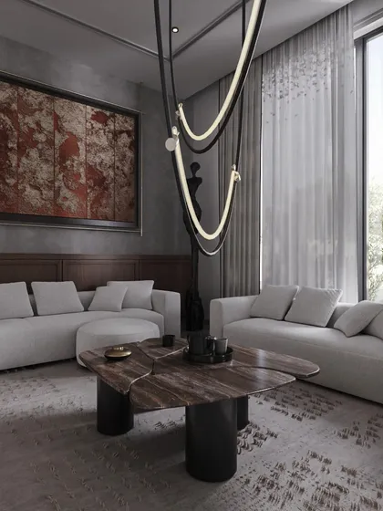 A sculptural stone coffee table and a unique hanging light fixture add layers of artistic expression to this living area. The design is calm and refined, with soft whites and greys warmed by touches of red and natural wood.