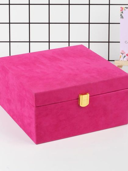 The elegant and reusable pink velvet box, closed. This packaging is part of the gift itself, perfect for storing keepsakes long after the skincare products are enjoyed.