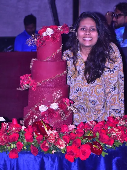 A proud moment standing next to one of my largest creations, a magnificent, multi-tiered red wedding cake, all set up and ready for the celebration.
