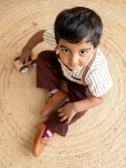 A little boy playing with his toy car, a simple moment of childhood captured from above.