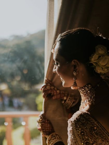 A beautiful, sun-kissed shot of the bride. The natural light enhances the glow from her dewy makeup.