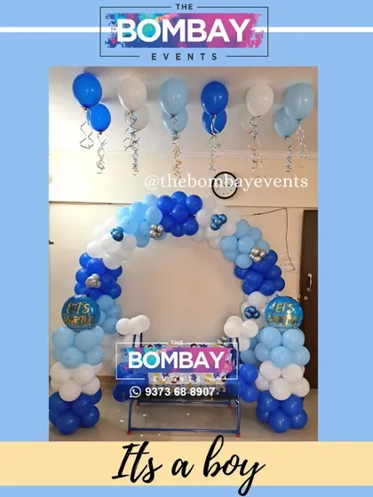 It's a boy! A simple yet charming naming ceremony setup with a blue and white balloon arch, perfect for a cozy home function.