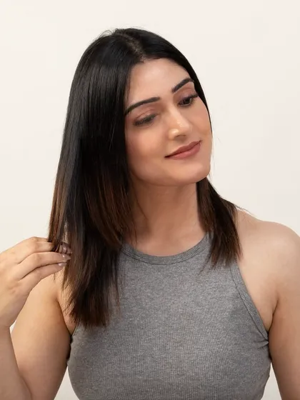 A model demonstrating the seamless look of hair extensions. This type of lifestyle photography helps customers visualize the product's end result and benefits.