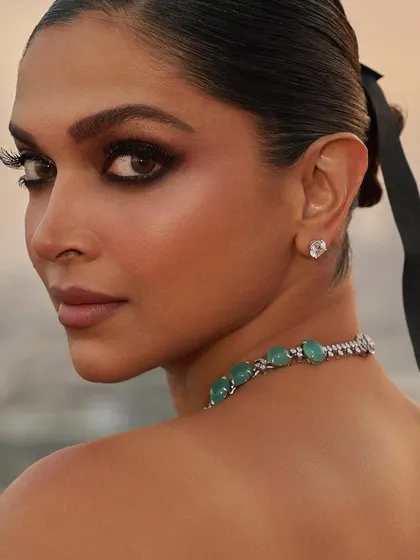 A detailed shot of Deepika Padukone, where the subtle gradient of her ombre nails is visible. This is a perfect example of my commitment to creating flawless, hand-crafted details.