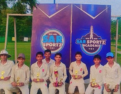 A team of young champions poses with their individual trophies after a victorious campaign.