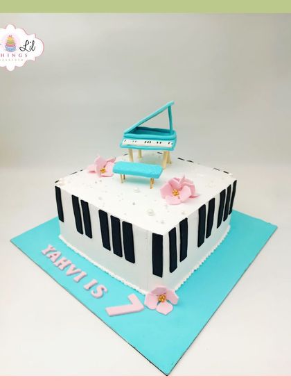 A sweet and simple piano-themed cake for Yahvi's 7th birthday, topped with a miniature grand piano.