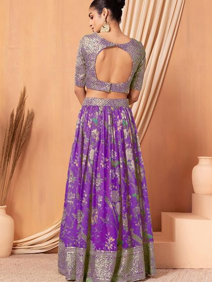 Make a bold statement in this purple organza lehenga. The sequined blouse and floral printed skirt create a look that's both glamorous and graceful.