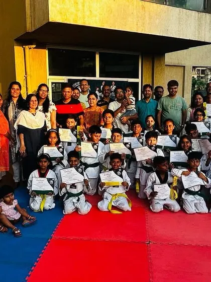 My students proudly displaying their new belts and certificates.