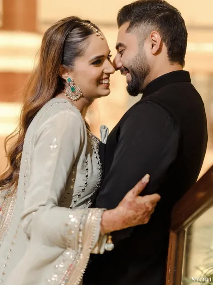 The couple sharing a playful and intimate "nose-to-nose" moment, their laughter captured perfectly.