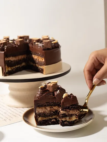The perfect forkful. This shot captures the rich, multi-layered goodness of the Snickers cake, a true fan favorite.