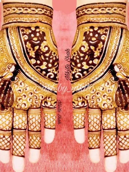A rich and intricate Indian henna design. The use of negative space around the peacocks makes them the central focus.