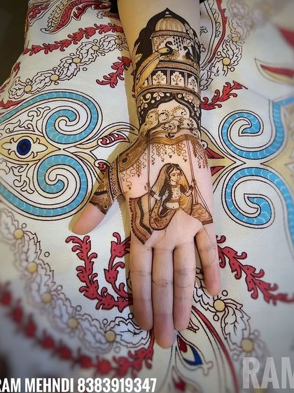 A beautiful design featuring a bride on a swing on the palm, with a palace and peacock design on the wrist.