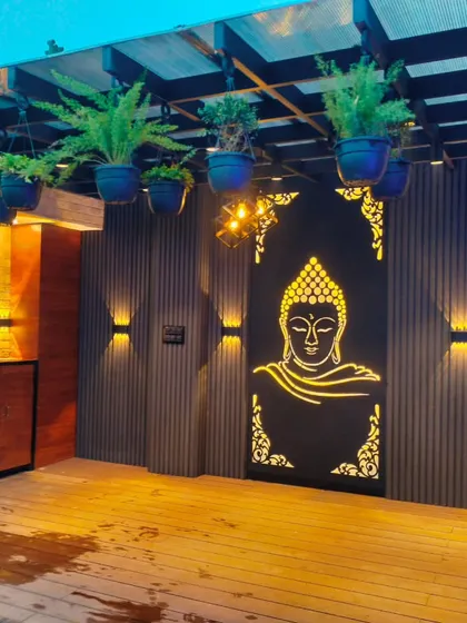 A close-up of the decorative Buddha panel and wooden cabinetry under the pergola, showcasing our attention to detail and custom features.