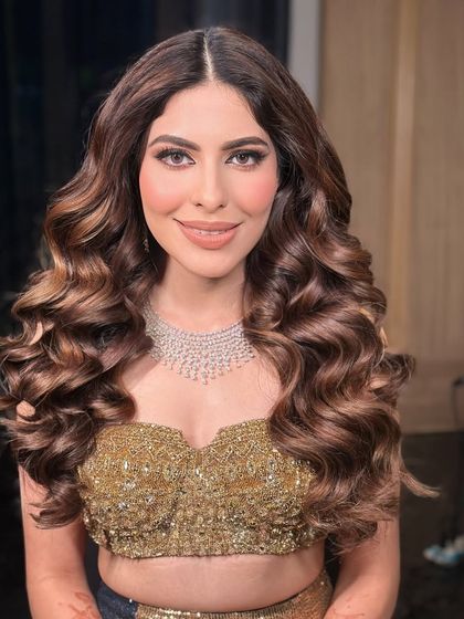 The client looking confident and glamorous with her voluminous curls for a cocktail event in Jaipur.