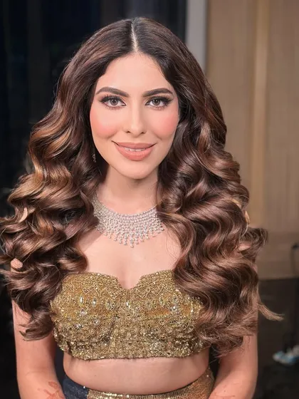 The client looking confident and glamorous with her voluminous curls for a cocktail event in Jaipur.