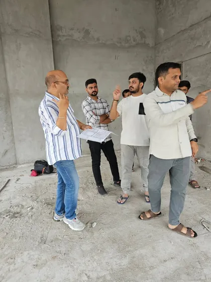 A group of clients listening intently as I explain the energy dynamics of their new workspace during a site visit.
