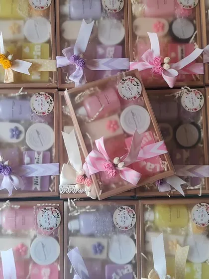 A large corporate order of personalized gift hampers. Each box is elegantly tied with a ribbon and contains a variety of my handmade bath products.