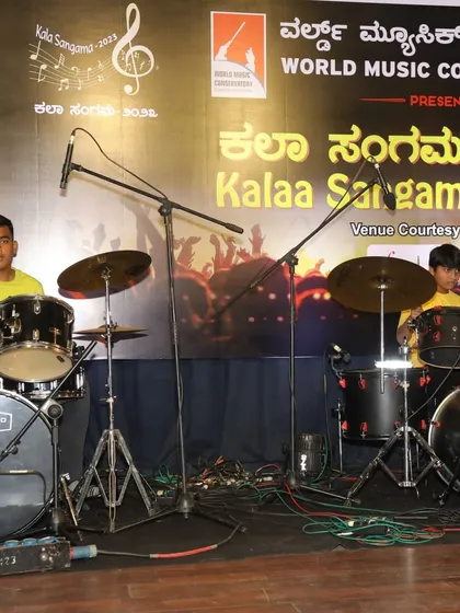 The drum duo, Hemanth and Manish, set up on stage for their performance.