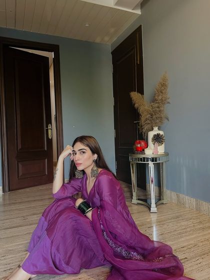 A relaxed pose in my purple Anarkali, showing the beautiful drape of the fabric and the intricate embroidery on the trousers.