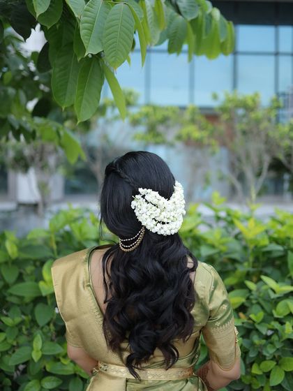 The hairstyle from the back, showing the beautiful placement of the mogra gajra. It's a classic and timeless choice for any South Indian bride.