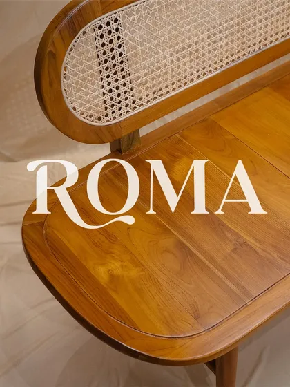 The 'Roma' bench, an artful fusion of strength and beauty. This custom teak wood bench features a solid, gently curved seat and an intricate rattan backrest.