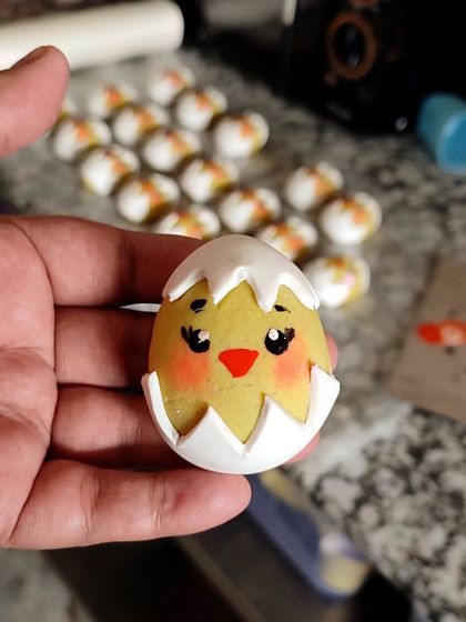 A close-up of one of my hand-painted marzipan Easter eggs. The cute expression and delicate details on this little chick show the love and artistry I put into every single piece.